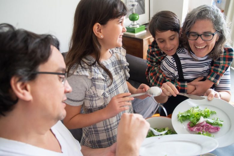 Happy family having breakfast together at home, sharing joyful moments and healthy food.